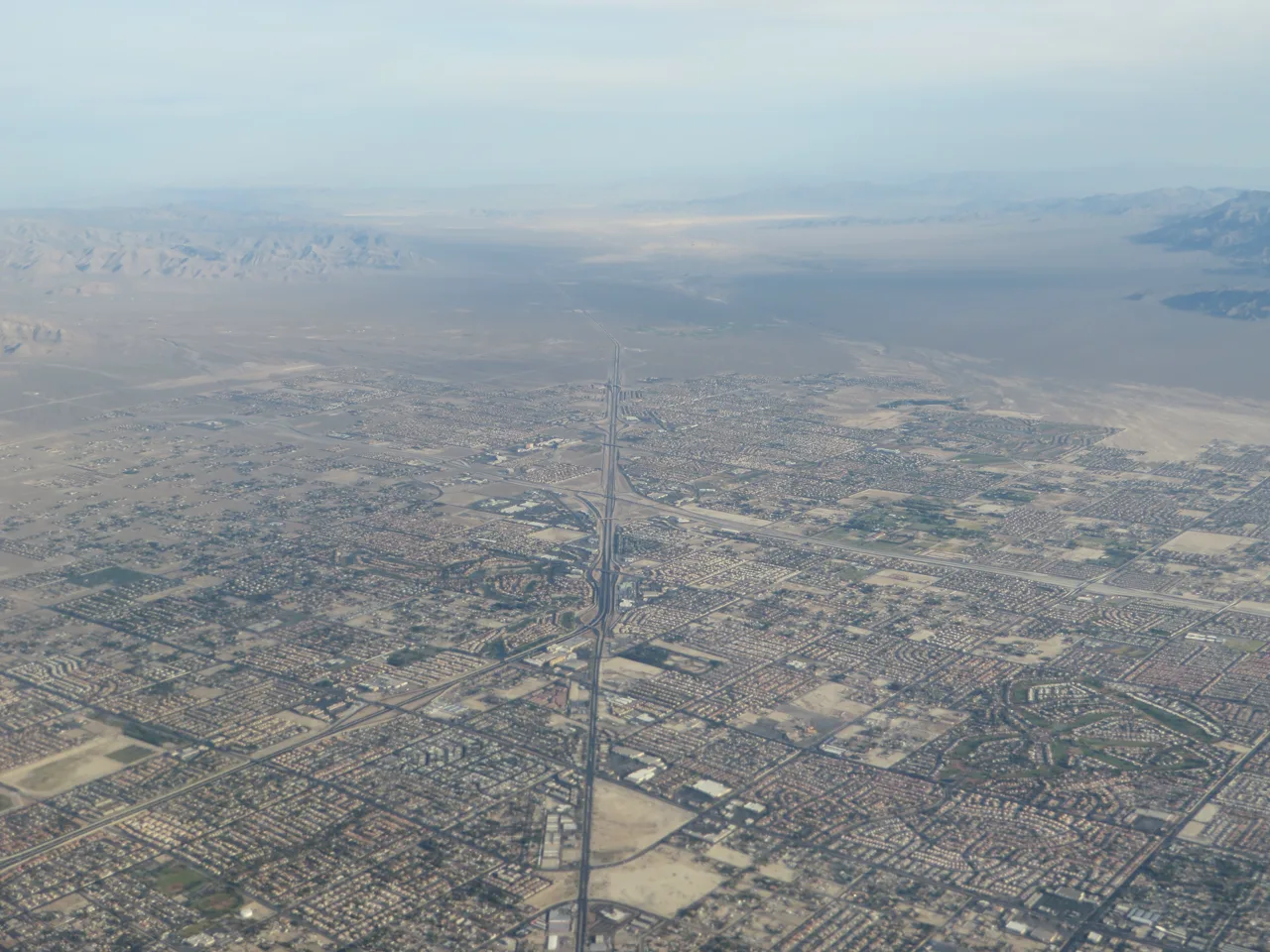 Aerial view of a Centennial Hills suburban neighborhood in northwest Las Vegas with mountains in the background