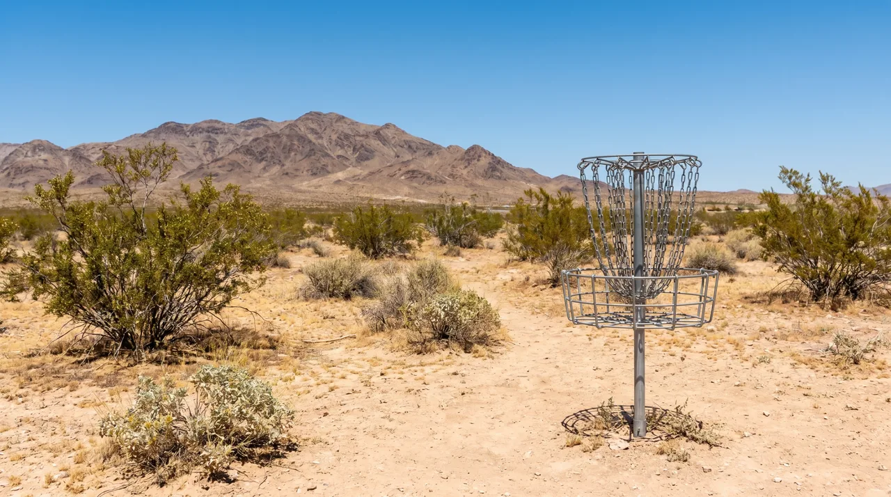 Metal disc golf basket on sandy desert ground at a Las Vegas park