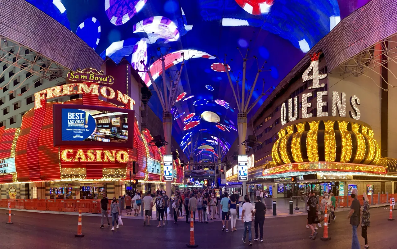 Pedestrians walking along Fremont Street Experience in downtown Las Vegas under the LED canopy