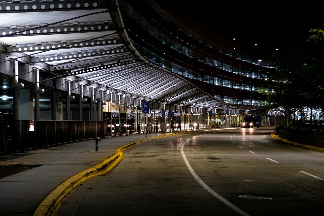Harry Reid International Airport exterior with a covered bus and shuttle pickup area