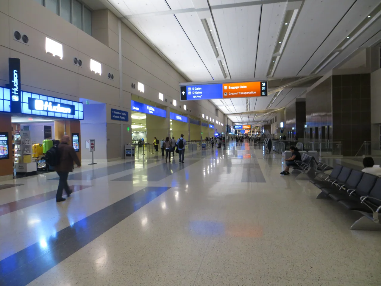 Interior of Harry Reid International Airport passenger terminal with travelers and modern signage