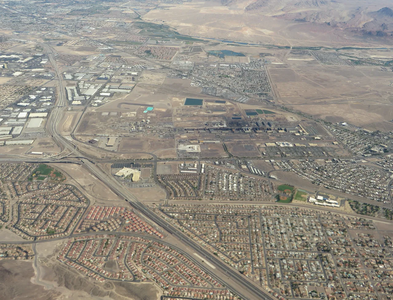 Aerial view of a Henderson, Nevada suburban neighborhood with red tile roofs and palm trees