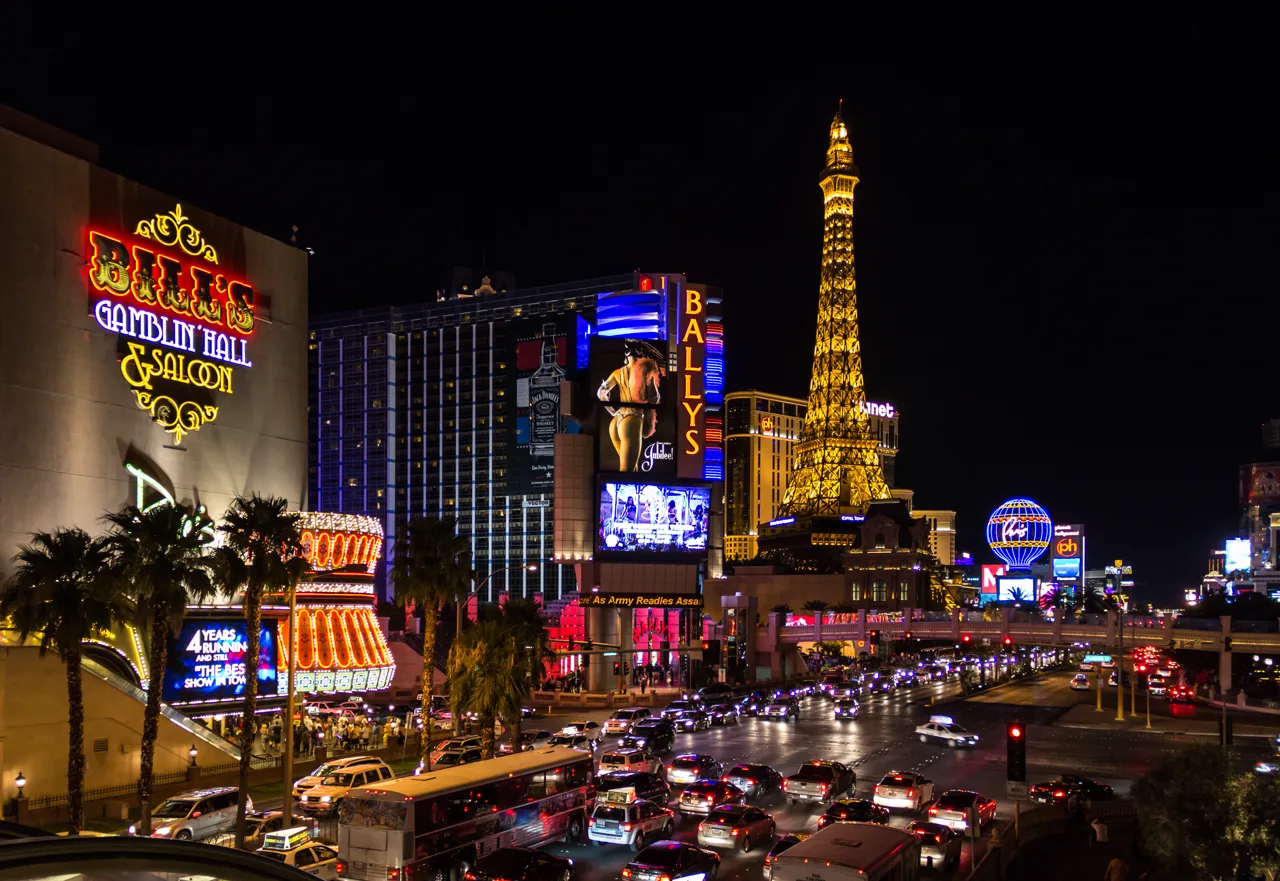 Las Vegas Strip street view along Las Vegas Boulevard with cars and palm trees lining the median