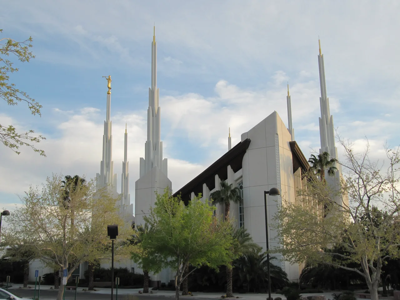 Exterior of the Las Vegas Nevada Temple with landscaped grounds and mountains in the background