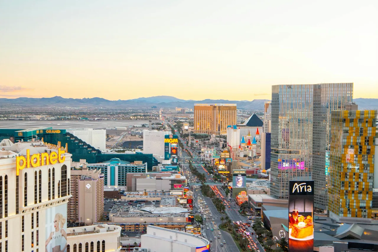 Las Vegas Strip skyline at dusk with city lights and desert mountains on the horizon