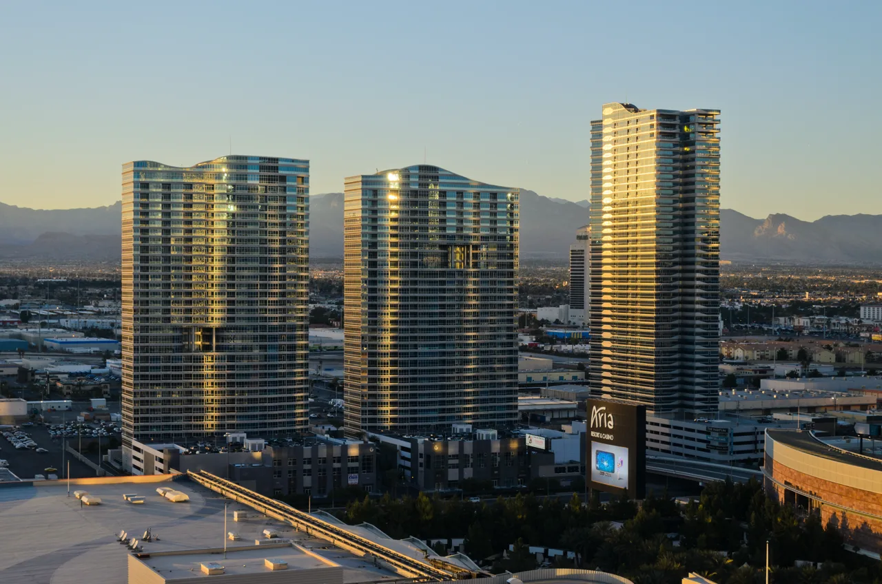 Tall glass high-rise condominium towers along the Las Vegas Strip against a clear blue sky