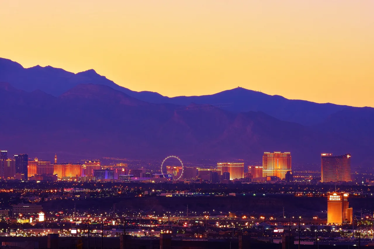 Las Vegas Strip skyline at golden hour with the desert mountains visible in the background