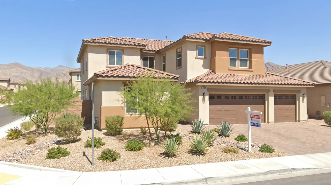 Modern Las Vegas suburban home with desert xeriscaped landscaping and a 'For Sale' sign in the front yard