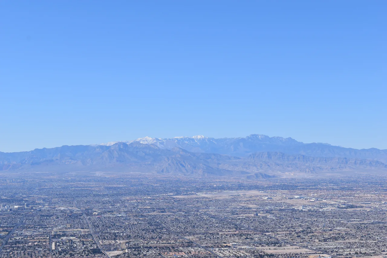 Wide panoramic view of the Las Vegas valley from an elevated vantage point showing the urban sprawl and surrounding mountains