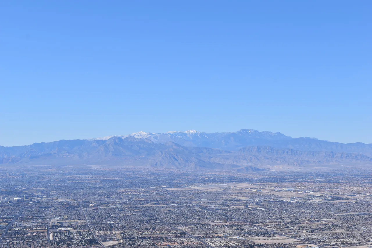 Wide view of the Las Vegas valley at sunset with the Spring Mountains rising in the background