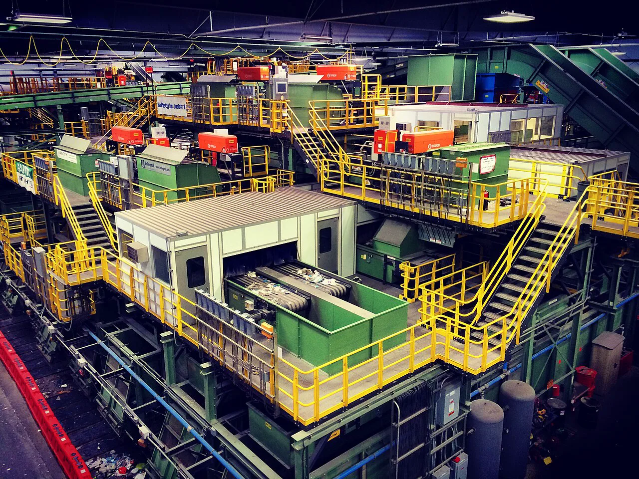 Interior of a single-stream recycling facility with conveyor belts and automated sorting equipment
