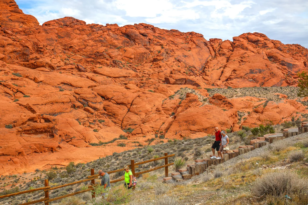 Red sandstone cliffs at Red Rock Canyon National Conservation Area with a hiking trail winding through the desert