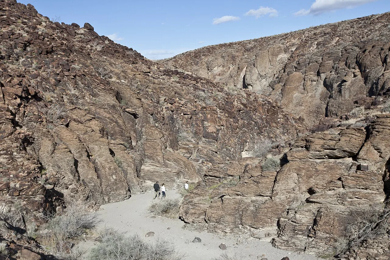 Rocky desert trail winding through Sloan Canyon National Conservation Area near Henderson