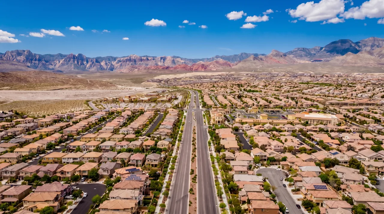Aerial view of a Summerlin master-planned neighborhood of single-story Las Vegas homes with Red Rock Canyon in the background