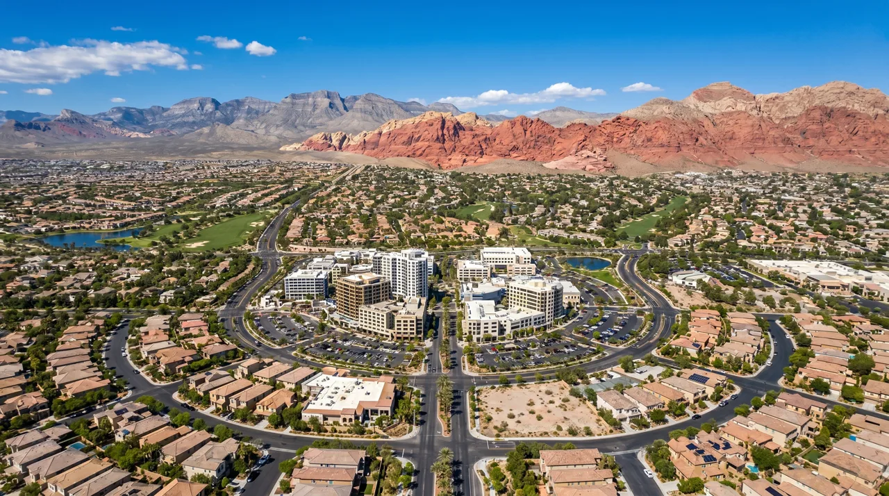 Aerial view of Downtown Summerlin and surrounding master-planned neighborhoods with Red Rock Canyon in the distance