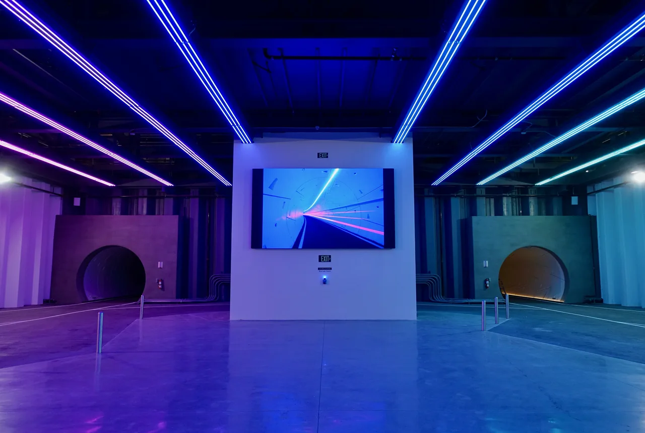 Tesla vehicle driving through a Boring Company Vegas Loop underground tunnel with LED lighting